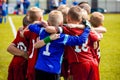 Young Children In Huddle Building Team Spirit