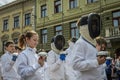 LVIV, UKRAINE - MAY 2018: Team of sportsmen in fencing goes in sports suits in the center of the city at the parade