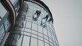 The team of steeplejacks climbs down the business center