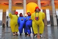 A team of street actors in carnival costumes pose for photos