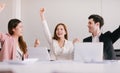 Team of successful business people is celebrating the receiving of positive answer from the investors. Royalty Free Stock Photo