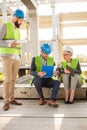 Team of successful young business partners having a meeting on a construction site Royalty Free Stock Photo