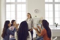 Team of supportive women applauding colleague for presentation in corporate meeting Royalty Free Stock Photo