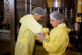 Team technician checking and maintenance quality of producing automated machine bottling wine in factory. Royalty Free Stock Photo