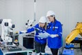 Team technician engineer using tablet control automation robotics at industrial modern factory. woman work at factory innovation