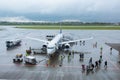 A team of technicians prepares the plane for departure