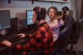 Team of teenage gamers plays in a multiplayer video game on pc in a gaming club. Royalty Free Stock Photo