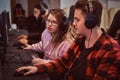 Team of teenage gamers plays in a multiplayer video game on pc in a gaming club. Royalty Free Stock Photo
