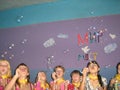 A team of teenage girls at the festival blowing bubbles.