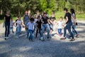 Team of teenagers playing yard football with a children team at sunny day Royalty Free Stock Photo