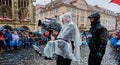 Team of a television station with waterproof packed camera equipment during video recordings of the carnival procession