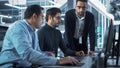 Team of Three Handsome Talented Young Engineers Use Computer to Discuss a Technological Project in