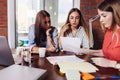 Team of three serious female colleagues looking , reading, studying the documents working in office Royalty Free Stock Photo