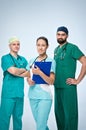 A team of three young doctors. The team included a doctor and a woman, two men doctors. They are dressed in green scrubs. Royalty Free Stock Photo