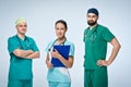 A team of three young doctors. The team included a doctor and a woman, two men doctors. They are dressed in scrubs. Royalty Free Stock Photo