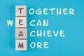 Team, together we can achieve more is standing on wooden cubes, business concept, teamwork strategy Royalty Free Stock Photo