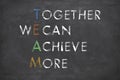 TEAM together we can achieve more with white chalk on a black background. Teamwork, synergy or business cooperation concept Royalty Free Stock Photo