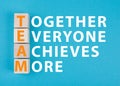 Team, together everyone achieves more is standing on a blue colored background