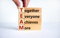 TEAM, together everyone achieves more symbol. Wooden cubes with words `TEAM, together everyone achieves more`. Beautiful white