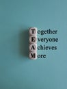 TEAM, together everyone achieves more symbol. Wooden cubes with words \'TEAM Royalty Free Stock Photo