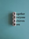 TEAM, together everyone achieves more symbol. Wooden cubes with words \'TEAM, together everyone achieves more\' Royalty Free Stock Photo