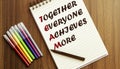 TEAM TOGETHER EVERYONE ACHIEVES MORE. your future target searching, a marker, pen, three colored pencils and a notebook for