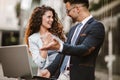 Two business people working together outdoors using laptop Royalty Free Stock Photo