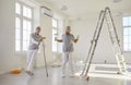 Team Of Two Happy Male Painters Dancing During Home Renovation Royalty Free Stock Photo