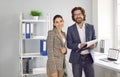 Team of two happy successful young business people working in their modern office Royalty Free Stock Photo