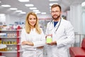 Team of two pharmacists is showing medicine box presentation in pharmacy store Royalty Free Stock Photo