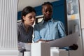 Team of two women architects colleagues collaborating looking down at blueprins Royalty Free Stock Photo