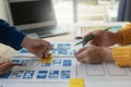 A team of UI UX web designers is working together to develop a mobile responsive website by previewing UI UX Front Royalty Free Stock Photo