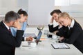Unhappy Businesspeople In Business Meeting