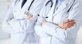 Team of unknown doctors standing straight with arms crossed in hospital. Physicians ready to help. Healthcare, insurance Royalty Free Stock Photo