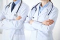 Team of unknown doctors standing straight with arms crossed in hospital. Physicians ready to help. Healthcare, insurance Royalty Free Stock Photo