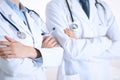 Team of unknown doctors standing straight with arms crossed in hospital. Physicians ready to help. Healthcare, insurance Royalty Free Stock Photo