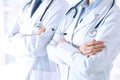 Team of unknown doctors standing straight with arms crossed in hospital. Physicians ready to help. Healthcare, insurance Royalty Free Stock Photo