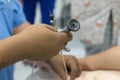 A team of urologist doctors performing a cystoscopy using a cystoscope. In a sterile operating room. close-up