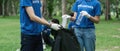 Team volunteers collecting garbage in public park. Environmental protection Concept