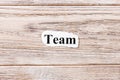 TEAM of the word on paper. concept. Words of TEAM on a wooden background Royalty Free Stock Photo