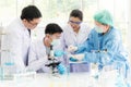 Team work asia woman and man Scientists analyzing study data and evaluating microscope success for work shop Royalty Free Stock Photo