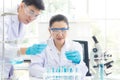 Team work asian woman and man Scientists analyzing study data and evaluating microscope success for work shop Royalty Free Stock Photo