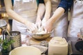 Team work. Beating bread dough