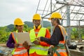 Team work construction engineer technician and worker control in the construction of roof structures on construction site Royalty Free Stock Photo