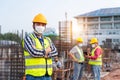 Team work of Construction engineers technician and  architect supervising progress stand in control of building foundations Royalty Free Stock Photo