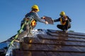 Team work construction worker install new ceramic tile roof with Roofing tools electric drill used in the construction site Royalty Free Stock Photo