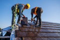 Team work construction worker install new ceramic tile roof in the construction site Royalty Free Stock Photo