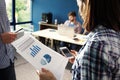 Team work discussing. Open space office and startup crew brainstorming at new project. Young woman with paper folder Royalty Free Stock Photo