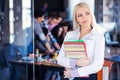 Team work discussing. Open space office and startup crew brainstorming at new project. Young women with paper folder. Royalty Free Stock Photo