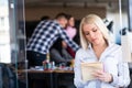 Team work discussing. Open space office and startup crew brainstorming at new project. Young women with paper folder. Royalty Free Stock Photo